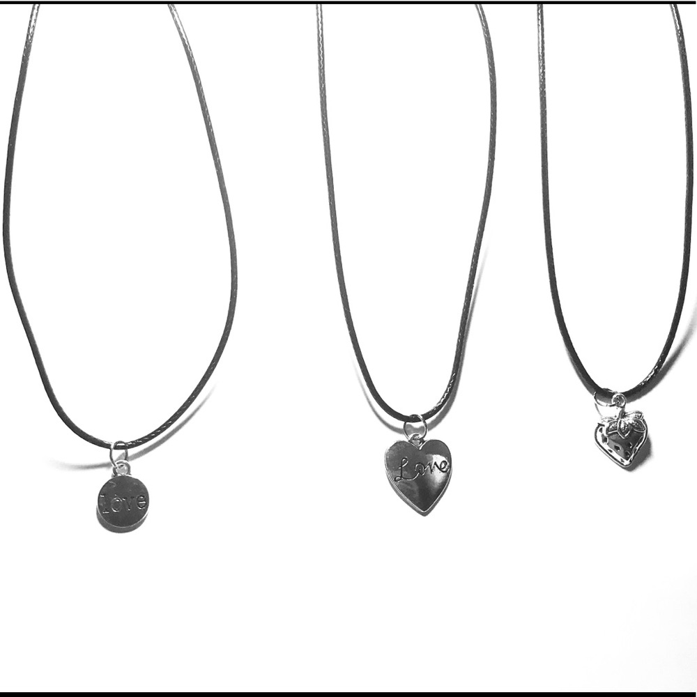 3 three black cord necklaces with charms.